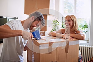 Couple packing boxes while moving house