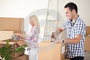 Couple packing moving boxes