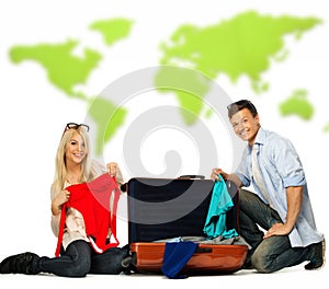 Couple packing suitcase for a journey