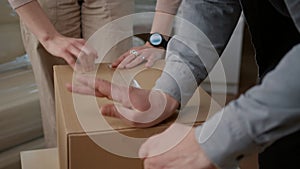 Couple packing up storage things in cardboard boxes