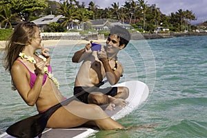 Couple on paddle board photographing