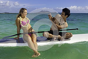 Couple on paddle board photographing