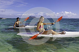 Couple paddling surfskis