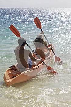 Couple paddling their kayak