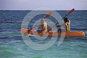 Couple paddling their kayak