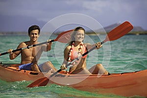 Couple paddling their kayak photo