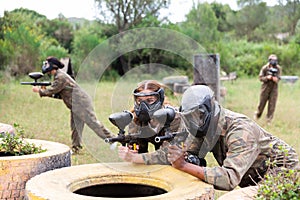 Couple of paintball players playing paintboll outdoors