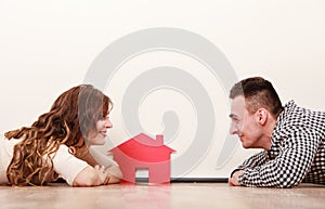 Couple with paper house. Housing real estate.