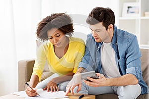 Couple with papers and calculator at home