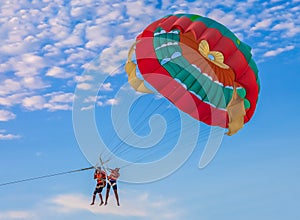 Couple parasailing on the beach