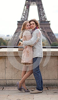 Couple in Paris by the Eiffel Tower, hugging