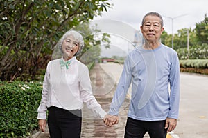 Couple in the park near home to relax, health and exercise in love sports, old man and senior woman taking a walk outdoors