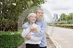 Couple in the park near home to relax, health and exercise in love sports, old man and senior woman taking a walk outdoors