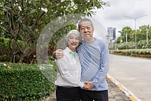 Couple in the park near home to relax, health and exercise in love sports, old man and senior woman taking a walk outdoors