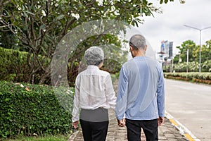 Couple in the park near home to relax, health and exercise in love sports, old man and senior woman taking a walk outdoors