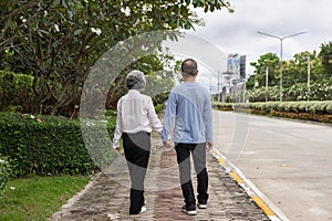 Couple in the park near home to relax, health and exercise in love sports, old man and senior woman taking a walk outdoors
