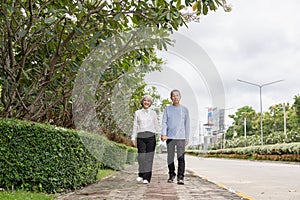 Couple in the park near home to relax, health and exercise in love sports, old man and senior woman taking a walk outdoors