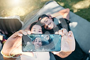 Couple in park, phone selfie and lying on blanket to relax on romantic picnic and spending quality time together. Love