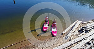 Couple parking paddleboard at riverbank on a sunny day 4k