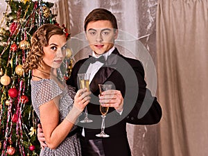Couple on party near Christmas tree.