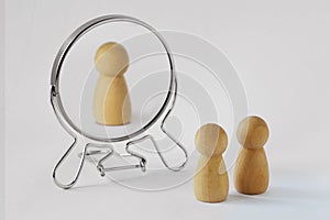 Couple of pawns looking in the mirror with just one of them reflected in it - Concept of egoism and narcissist