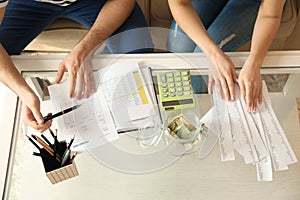 Couple with pay bills, calculator and money counting expenses indoors. Money savings concept