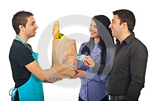 Couple paying with credit card at grocery