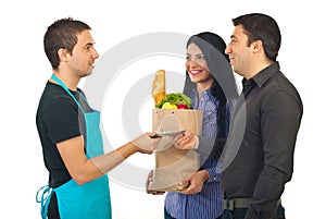 Couple paying with money their food at market