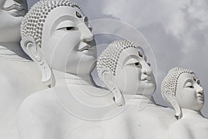 Couple peaceful white buddha statues sitting well alignment and decorating wonderful attractive mirror