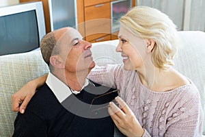 Couple pensioners together on sofa at home