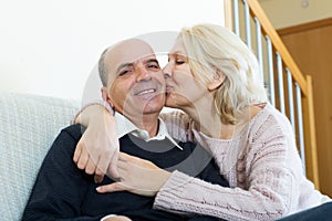 Couple pensioners together on sofa at home