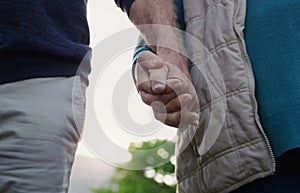 Couple, people and holding hands in outdoor for walk, together and support in London. Relationship, date and bonding for