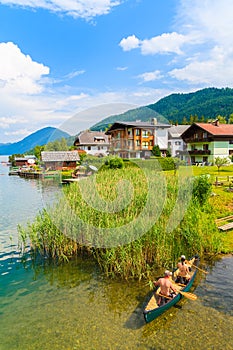 Couple of people in kayak on shore of beautiful Weissensee lake in Alps Mountains, Austria