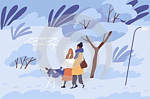 Couple of people walking with dog in winter park in cold freezing weather. Scene of happy friends enjoying stroll with