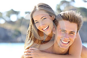 Couple with perfect smile posing on the beach