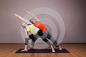Couple perform series of Extended Side Angle yoga partner pose