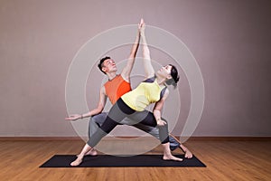 Couple perform series of Extended Side Angle yoga partner pose
