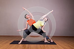 Couple perform series of Extended Side Angle yoga partner pose