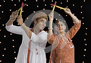 Couple performing Dandiya Raas on Navratri