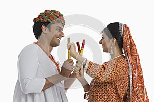 Couple performing Dandiya Raas on Navratri