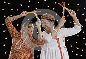 Couple performing Dandiya Raas on Navratri