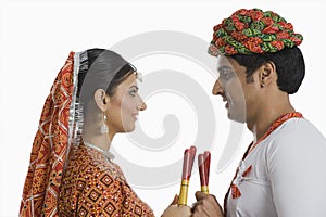 Couple performing Dandiya Raas at Navratri