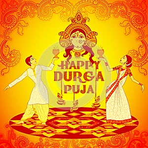 Couple performing Dhunuchi dance of Bengal for Durga Puja