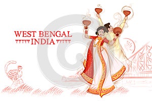 couple performing Dhunuchi dance traditional folk dance of West Bengal, India