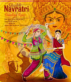 Couple performing Garba dance in Dandiya Raas for Dussehra or Navratri