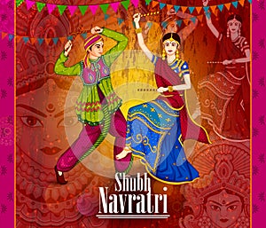 Couple performing Garba dance in Dandiya Raas for Dussehra or Navratri