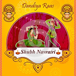 Couple performing Garba dance in Dandiya Raas for Dussehra or Navratri