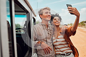 Couple, phone selfie and safari travel on game drive in nature environment, sand desert or dry Kenya landscape. Smile