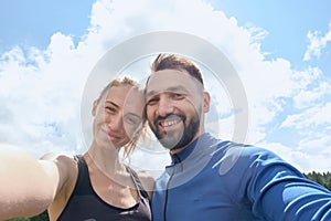 Couple photographing themselves while hiking in summer