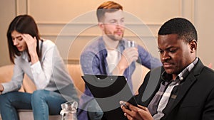 Couple at phycologist appointment sitting in modern office